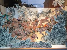 a display case with an image of zebras and other animals