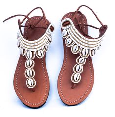 Karembo Padded leather sandal has detail classy look embelished with shells and recycled glass beads colour of bead is white gold.SIZE CHART 37 38 39 40 41 42 43 EUROPEAN6 7 8 9 10 11 12 US 23 cm 24 cm 25 cm 26 cm 27 cm 28 cms 29 cms DIMENSIONS White Beaded Sandals For Vacation, Gold Embellished Leather Sandals, Embellished Gold Leather Sandals, White Leather Toe Ring Sandals For Beach, White Beaded Sandals With Round Toe, Gold Beaded Sandals For Vacation, Gold Beaded Sandals For Festival, White Beaded Beach Sandals, Beach Embellished Leather Sandals