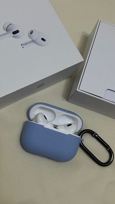 an open box with two airpods in it