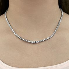 Here is a fine pick for a diamond necklace that boasts extra glitz. This eternity necklace or tennis necklace features a sparkling line of diamonds, each secured by four prongs. The diamonds gently graduate in size all the way up to the clasp.