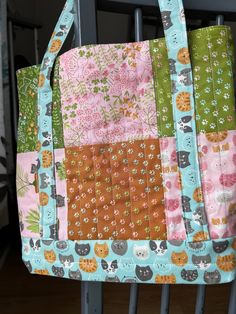 a multicolored patchwork purse sitting on top of a chair