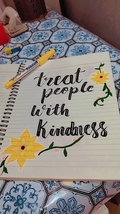 a notepad with the words treat people with kindness written on it