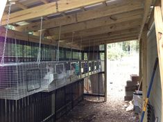 a group of animals inside of a wooden structure with chains hanging from it's sides