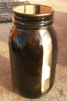 a brown jar sitting on top of a sidewalk