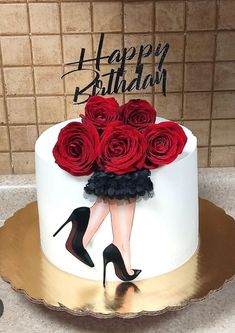 a birthday cake decorated with red roses and high heels