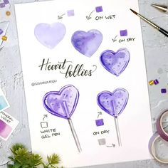 some watercolor hearts are on top of a piece of paper