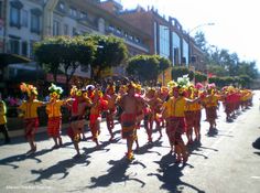 a group of people that are standing in the street with some kind of costume on