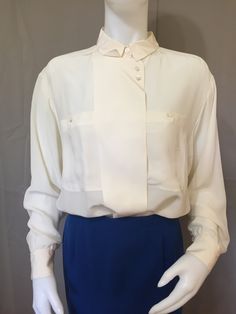 980s button up blouse 100% silk, mother of pearl buttons, false lapel button front. Perfect condition, never worn. Semi-formal Collared Blouse With Placket, Chic Semi-formal Blouse With Buttons, Classic Blouse With Covered Buttons And Collar, Classic Blouse With Covered Buttons, Chic Blouse With Buttons And Spread Collar, Chic Blouse With Spread Collar And Buttons, Silk Top With Lapel Collar For Formal Occasions, Chic Semi-formal Shirt With Buttons, Classic Silk Blouse For Formal Occasion