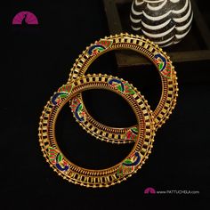 This is a beautiful pair of gold tone bangles crafted with beads border and Peacock enamels. Size : 2.6 PLEASE NOTE: * This is an imitation/fancy jewellery and don't come with any precious metals or stones. It is handmade and slight inconsistencies, if any, in production are not considered defects, and it adds to the character and uniqueness of the product. * The color/texture of the product you see in the pictures might vary slightly with the original depending on the screen settings of your gadget - factors such as the screen brightness, color setting, blue light filter, or white balance of your monitor/screen. Please reach out to us if you have doubts about the color. *No exchange or returns applicable. White Balance, Bangles Indian, Bead Bangles, Light Filter, Fancy Jewellery, Enamels, Stone Gold, Indian Jewellery, Color Textures