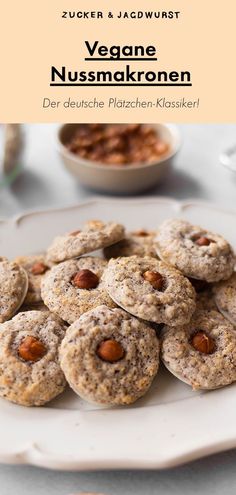 a white plate topped with cookies covered in nuts