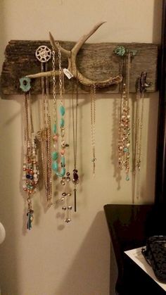 there is a wooden rack with many necklaces hanging on it