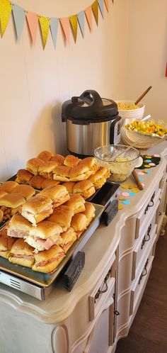 there are many sandwiches on the buffet table