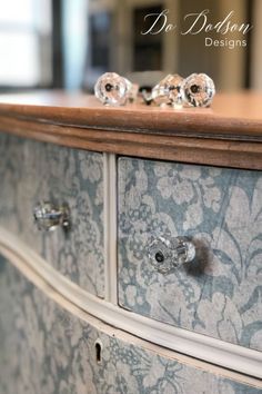 an old dresser with glass knobs on it