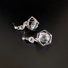 Unusual, sparkly diamond shaped crystals are captured in silver plated cages. I have joined them to the crystal, non allergenic, stainless steel posts with chain maille. Nice neutral earrings will go with anything. Makes a lovely gift. Here is a link to my whole shop: https://www.etsy.com/shop/designsbymalone RETURNS - BUY WITH CONFIDENCE Don't worry, I will refund or exchange an item up to 60 days. Makes gift giving easy! All my items will arrive in a gift box and/or a velvet or organza pouch. Sparkling Stone Metal Earrings For Gift, Party Crystal Earrings For Pierced Ears, Party Clear Crystal Earrings For Pierced Ears, Clear Pierced Jewelry For Party, Silver Crystal Dangle Earrings With Sparkling Stones, Diamond White Pierced Party Earrings, Party Earrings With Clear Metal, Nickel Free Crystal Earrings For Party, Silver Metal Crystal Earrings For Party