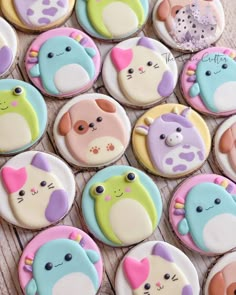 many decorated cookies are arranged on a table