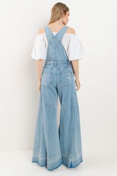 Choose comfort and style with the Women's Distressed Wide Leg Denim Overall. The adjustable straps, kangaroo chest pocket, and front and back pockets provide convenience, while the wide western legs, side buttons, and distressed accents add a trendy touch. Stay on trend in these comfortable, boho-inspired overalls. 34" INSEAM SLEEVELESSBUCKLE CLOSUREADJUSTABLE STRAPSKANGAROO CHEST POCKETFRONT/BACK POCKETSWIDE LEG Denim Bib Front Bottoms For Fall, Casual Jeans With Suspenders In Medium Wash, Medium Wash Wide-leg Overalls With Pockets, Light Wash Overalls With Pockets For Fall, Fall Light Wash Overalls With Pockets, Spring Jeans With Adjustable Straps, Full Length Overalls With Pockets For Spring, Spring Dark Wash Denim Jumpsuit With Adjustable Straps, Medium Wash Denim Jeans With Suspenders