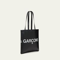 Comme des Garcons tote bag in smooth leather features a "Huge Logo" design Foiled logo lettering Two flat top handles Open top Interior, one zip pocket Approx. 25.984"H  x 15.748"W x 0.787"D Leather Imported Classic Leather Bag With Logo, Leather Shoulder Bag With Engraved Logo For Shopping, Designer Bags With Embossed Logo For Daily Use, Designer Rectangular Bag With Engraved Logo, Top Handle Shoulder Bag With Engraved Logo For Shopping, Leather Tote Shoulder Bag With Logo, Luxury Bags With Engraved Logo For Daily Use, Designer Bags With Embossed Logo For Everyday Use, Luxury Bags With Engraved Logo For Shopping