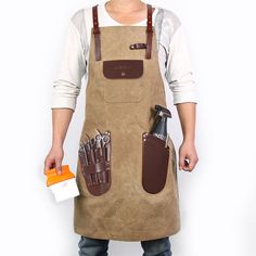 a man wearing an apron and holding tools