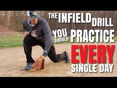 a man kneeling down on top of a baseball field next to a wooden ball bat