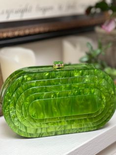 This pearlized resin clutch in agave green has an art deco flare that will add sophistication to any of your looks Can be worn as a clutch or Crossbody Measuring 8.25 x 4.5 “ This purse fits an iPhone plus Trendy Green Rectangular Clutch, Chic Green Rectangular Evening Bag, Trendy Green Clutch As A Gift, Trendy Green Clutch As Gift, Trendy Green Clutch For Gift, Luxury Green Rectangular Clutch, Green Rectangular Evening Bag For Events, Luxury Green Clutch Evening Bag, Chic Green Evening Bag For Formal Events