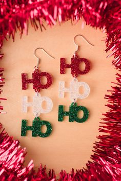 These earrings are made with acrylic Ho Ho Ho charms! Fun, festive and lightweight! Available with nickel free silver or gold hardware.