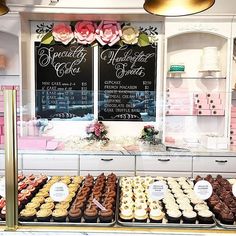 a display case filled with lots of different types of doughnuts and pastries