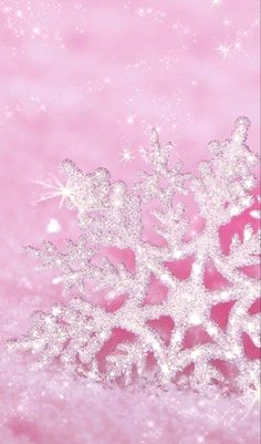 a snowflake is shown against a pink background