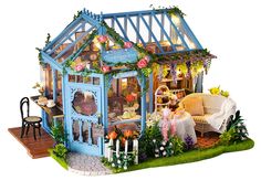 a doll house with furniture and flowers on the front porch is shown in this image