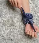 a woman's bare foot is tied up on the carpet