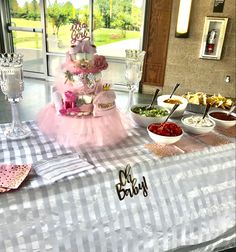 a table topped with lots of food and desserts on top of it's tables