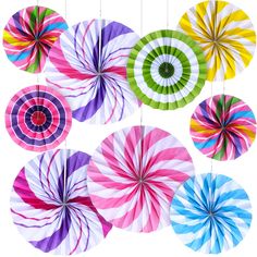 colorful paper fans hanging from strings on a white background, with circular designs in different colors