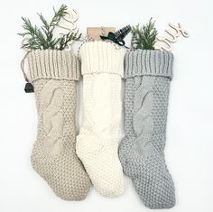 three knitted christmas stockings are lined up next to each other