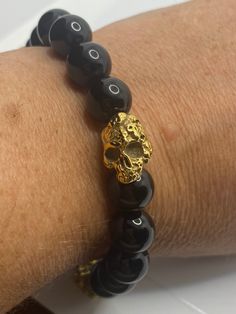 Vintage style Black onyx unisex mens stretch golden skull bracelet Cool vintage Style prayer beads bracelet. Stretches to 9 inches Unisex or for men. All jewelry is shipped in a nice gift box. Check out our over a THOUSAND great reviews Gold Adjustable Skull Bracelets, Adjustable Gold Skull Bracelets, Prayer Bead Bracelet, Louis Vuitton Fashion, Skull Bracelet, Vintage Mode, Jewelry Bracelet, Mens Jewelry Bracelet, Cool Vintage