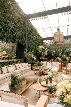 a room filled with lots of furniture and plants on top of it's walls