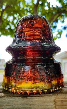 an old glass jar sitting on top of a wooden table