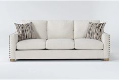 a white couch with two pillows on it