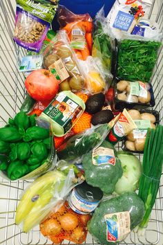 a shopping cart filled with lots of different types of fruits and vegtables