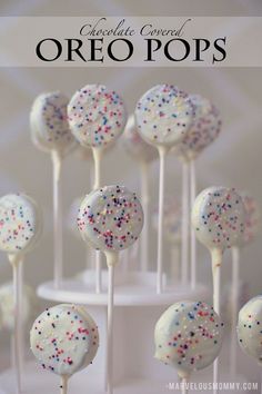 cake pops with white frosting and sprinkles are on top of each other