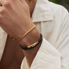 Featuring a clean and understated 18K gold barrel, this woven leather bracelet will add depth to your look by breaking up the metal. Its polished golden accents feature intricate clover detailing and a secure bayonet clasp for a comfortable fit. Wear it solo or stack it with your favourite gold rings for an instantly elevated look. ​​✓ 18K Gold & Leather✓ Water, Heat, Sweat Resistant✓ Hypoallergenic (No Green Skin)Model is 5'11 & Wears 7.5" Length. Golden Bracelets For Men, Bracelet Stack Men, Bracelet Photography, Gold Bracelet Simple, Skin Model, Mens Bracelets, Green Skin, Black Leather Bracelet, Mens Gold Bracelets