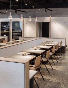 an empty restaurant with tables and chairs lined up against the wall in front of them