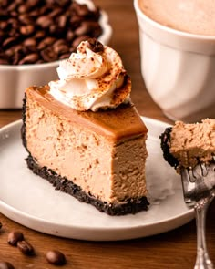 a piece of cheesecake with whipped cream on top and coffee beans in the background