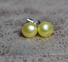 jewelry : yellow pearl earrings, real pearl stud earrings earring material:  freshwater pearl,sterling silver pearl grade: AAA Metal material: sterling silver pearl body: clean pearl luster: high pearl shape: button pearl size: 8mm pearl colour: yellow packaging: beautiful pouch Thank you for your viewing. The other pearl jewelries: https://www.etsy.com/shop/weddingpearl?ref=simple-shop-header-name&listing_id=1026507203&search_query=pearl go to my store: https://www.etsy.com/shop/weddingpearl?re Yellow Pearl Jewelry Gift, Yellow Packaging, Yellow Pearl Earrings, Real Pearl Earrings, Biwa Pearls, Yellow Pearl, Beaded Earring, Freshwater Pearl Earrings, Aquamarine Necklace