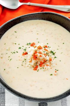 a bowl filled with soup and garnished with crumbled cheese on top