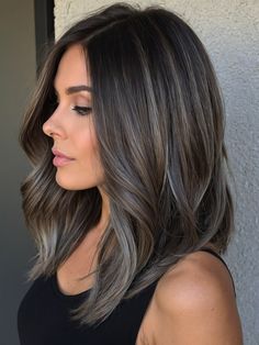 For those who prefer the understated elegance of cool tones, ashy balayage on dark brunette hair offers a chic, sophisticated option. This style uses shades of ash to create a muted, yet impactful contrast, perfect for adding a sleek, modern edge to your look. It’s an ideal choice for those looking to combine cool elegance with contemporary style.