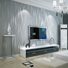 a modern living room with white furniture and grey wallpaper, including a large flat screen tv