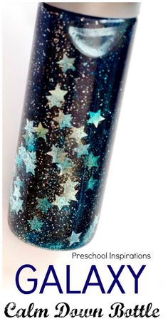 a glass bottle with stars painted on it and the words galaxy written in blue ink