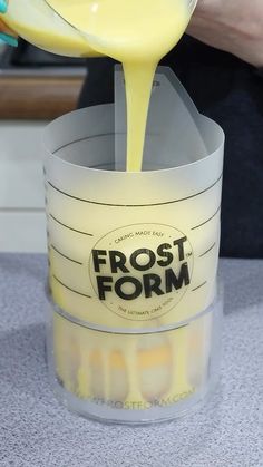 a person pours orange juice into a cup with the word frost form on it