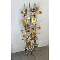 a sculpture made out of metal and gold squares