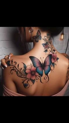 the back of a woman's neck with flowers and butterflies on it