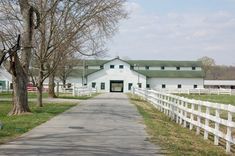 the barn is located on the side of the road